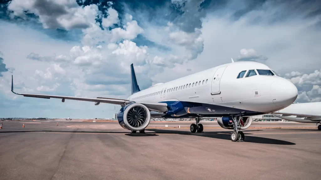 Airplane on the tarmac under a blue sky.