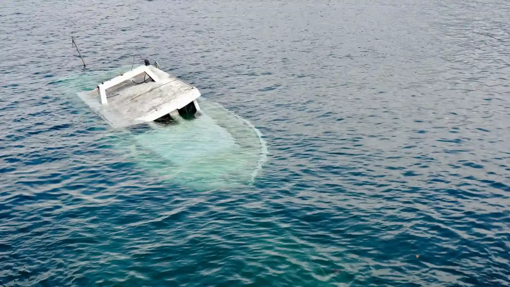 Capsized boat floating in the water.