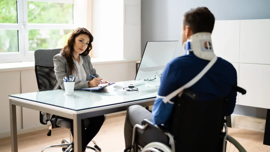 Injured man with neck brace consulting lawyer in office
