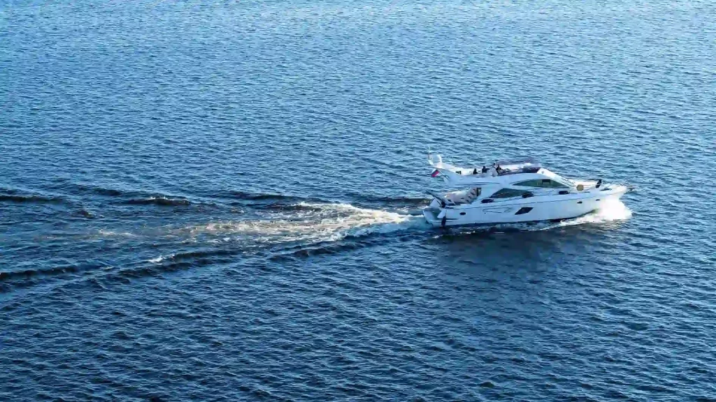 White yacht cruising on open water.