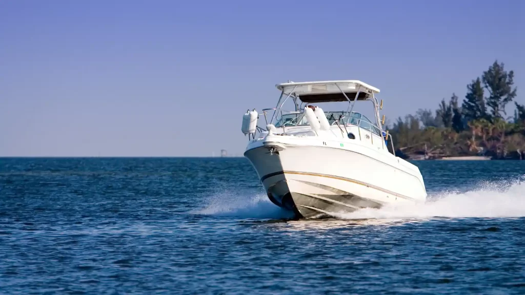 White motorboat speeding across blue water